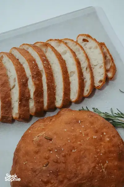 Focaccia loaves sliced on a tray with herb specks and a round loaf, served at a Singapore bread workshop — workshops in Singapore