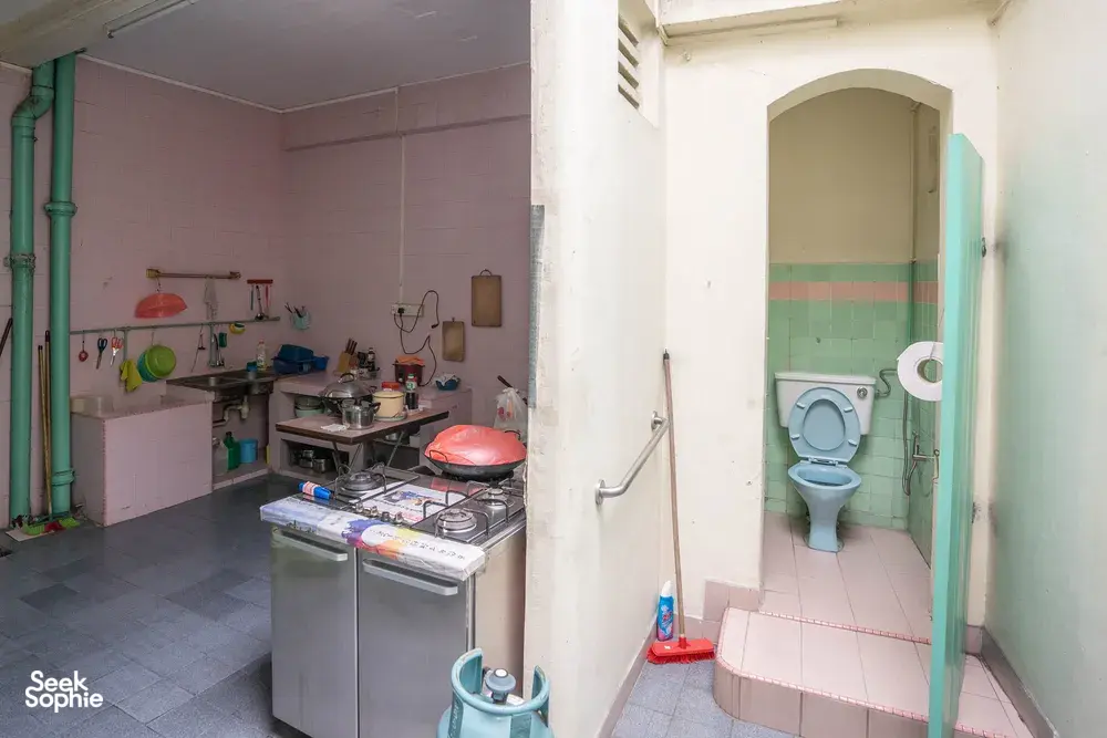 Abandoned kitchenette with a gas stove and tiled toilet in a Jalan Besar building, Singapore hidden gems