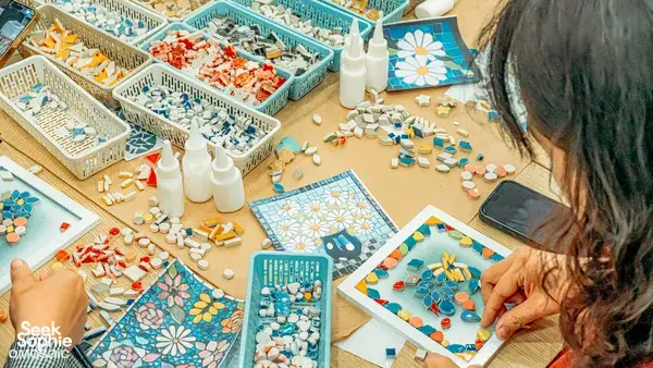 Workshop tables of ceramic mosaic kits as participants assemble colourful designs at QMosaic Artspace & Workshop in Bat Trang near Hanoi