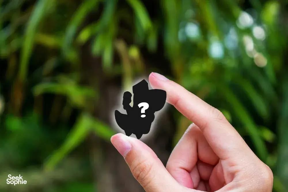 Hand holding a black puzzle icon with a question mark, set against Fort Canning greenery for Ransack team puzzle hunt in Singapore