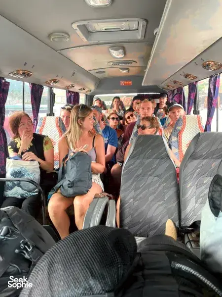 Travellers seated on a Son Tung Express bus during the Cat Ba to Halong Bay transfer, bright interior with rows
