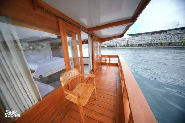 Wooden boat deck with a chair set, cruising in calm waters during a 3D2N join-in Komodo trip from Labuan Bajo to Komodo Island