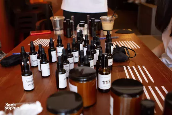 Rows of labelled essential-oil bottles and candle-making tools on a table for a Singapore candle workshop by Vcube Scenting