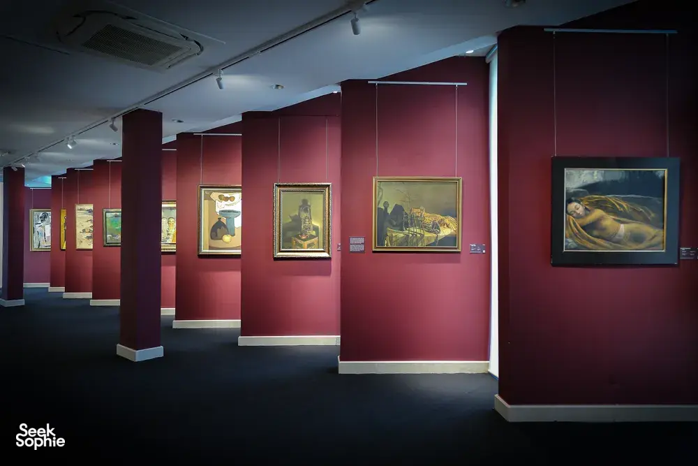 Visitors viewing Vietnamese artworks in gallery rooms at Quang San Art Museum during an expert-led tour in Ho Chi Minh City