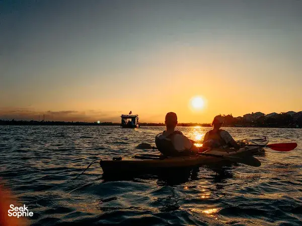 Sunset paddle on a kayak with two people on board in Hoi An, guided by Hoi An Kayak Tour as the sun dips low