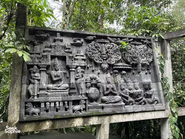 Carved stone relief panel with Hindu-Buddhist figures at Borobudur Temple, Yogyakarta for guided cultural sightseeing