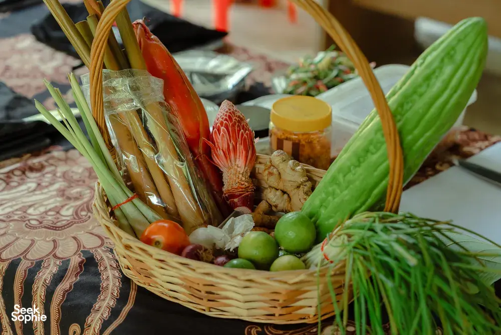 Basket of fresh prawns, herbs, ginger and greens laid out for Indigenous Sabahan cooking in Kota Kinabalu, Sabah