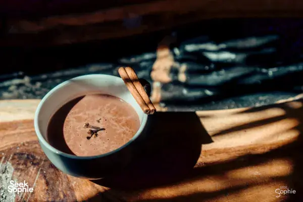 Melted chocolate in a bowl with a wooden tasting stick on a work surface during a bean-to-bar chocolate-making workshop in Singapore