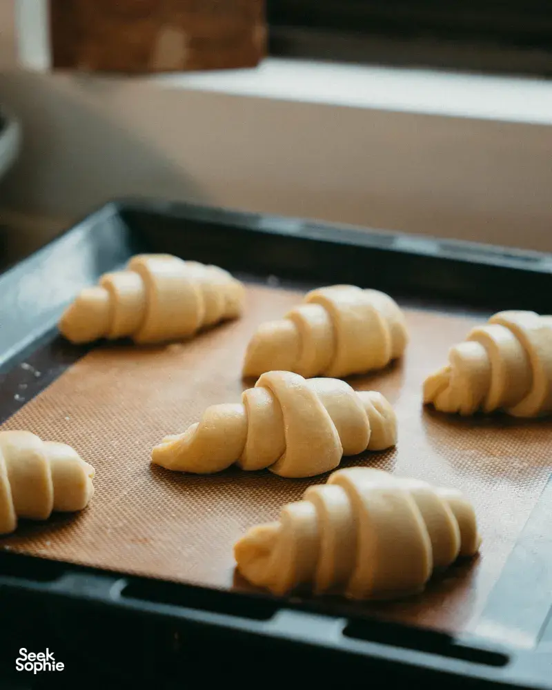 Shaped croissants on a baking tray, ready for the oven, during a French Cooking Lab workshop in Singapore