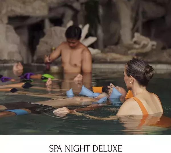 Guests relaxing in a warm soak outdoors during Spa Night Deluxe at Udara Yoga spa retreat in Canggu