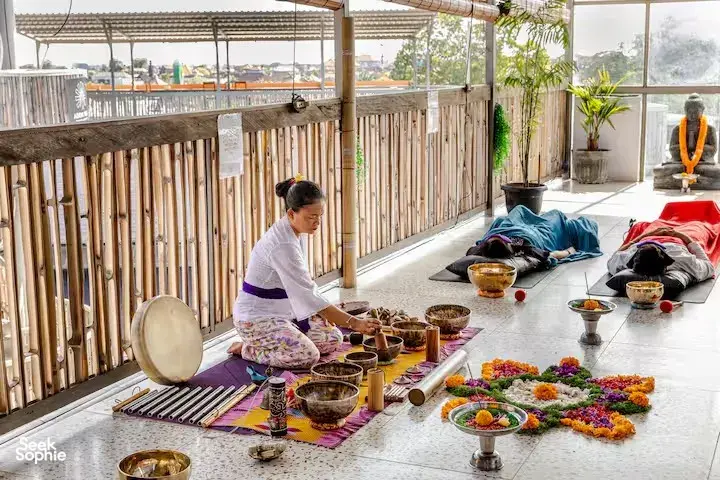 ADDA Yoga sound healing on a Canggu rooftop terrace, with multiple singing bowls and mats set out for meditation