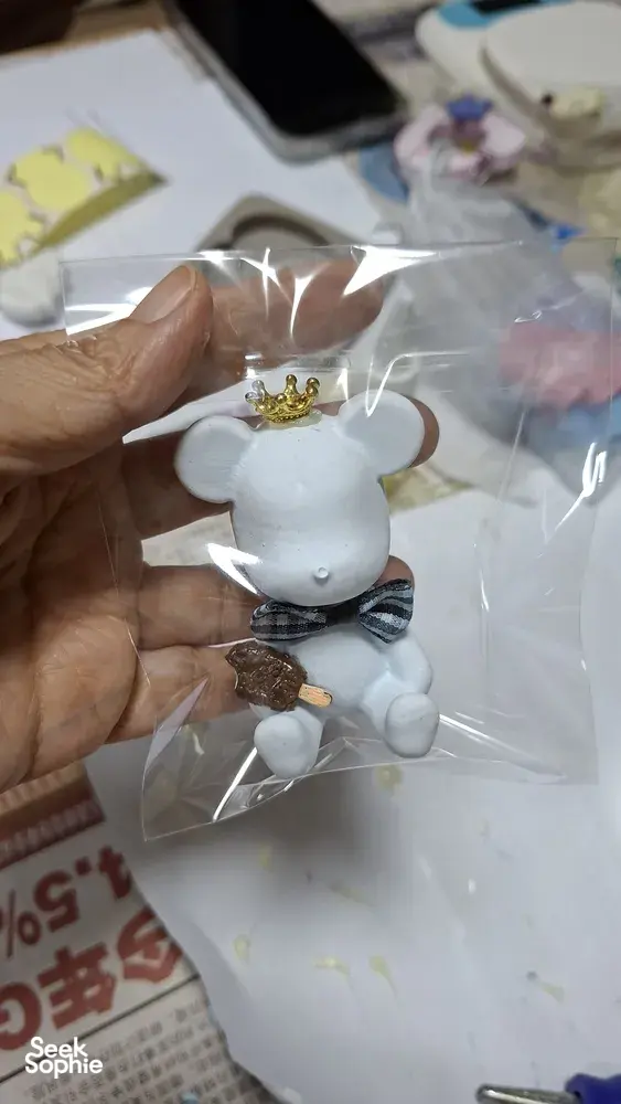 Crown-topped white marble scent stone figure in a clear bag, gift-ready from Unmi Lessons at workshops in Singapore