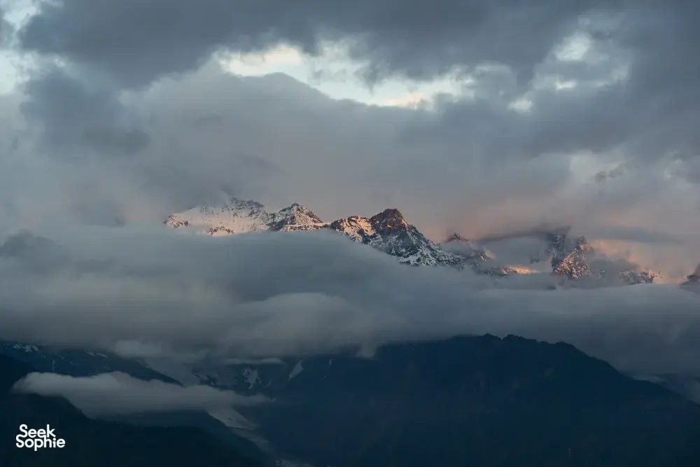 Meili Snow Mountain sunrise over the cloud-filled peaks during a 2D2N trek from Shangri-La, Yunnan
