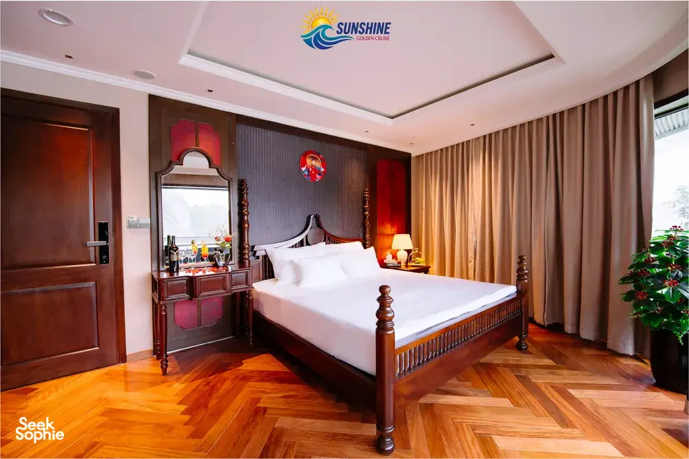 Sunshine Golden Cruises cabin interior with a neatly made bed, antique-style wooden dresser, mirrors and soft bedside lamps