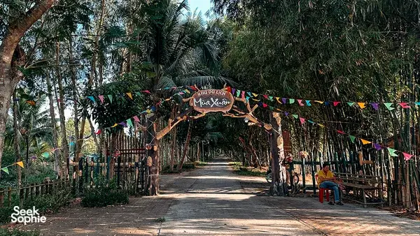 Bamboo and fenced walkway with string banners at a river-side spot in the Mekong Delta, a peaceful base for wildlife watching