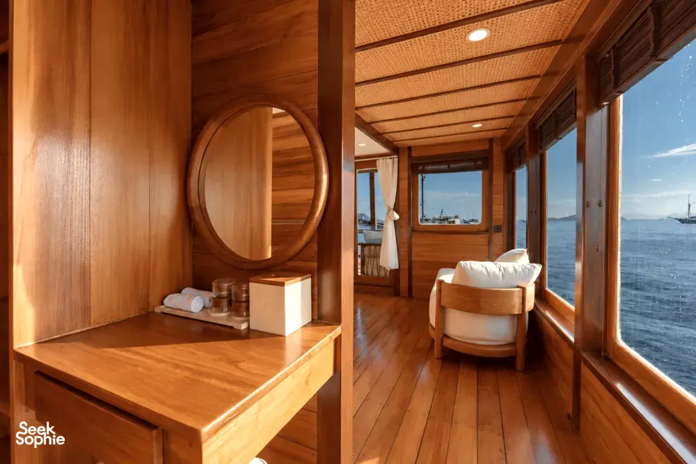 Wooden cabin corridor with circular porthole and ocean view, furnished for a rare 3D2N shared trip on Komodo Island