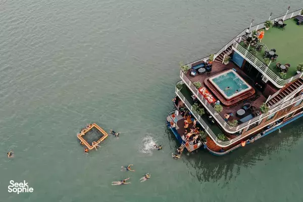 Overhead view of snorkellers and swimmers beside the La Casta pool deck on the ship’s steps on Halong Bay
