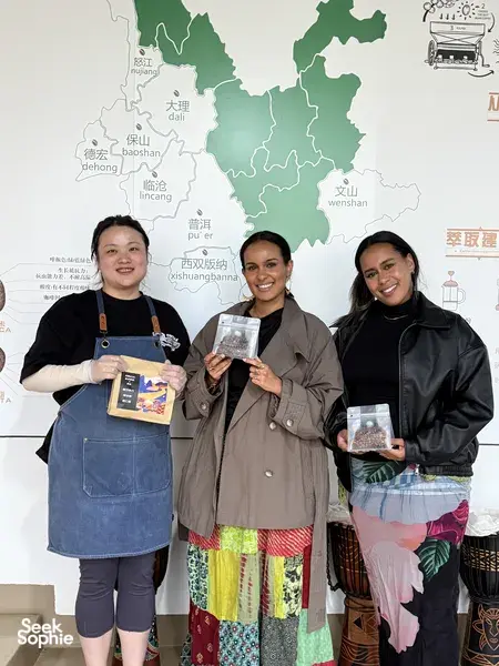 People holding packaged coffees in the Seeker Yunnan Coffee Estate workshop in Lijiang, learning about Yunnan origins