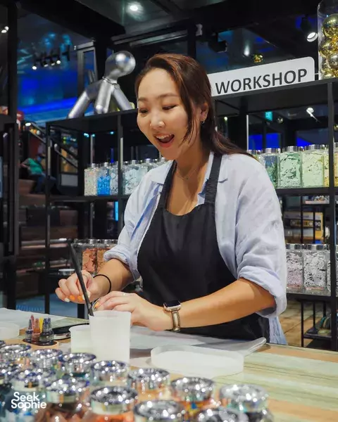 Maker painting a coaster base at a bright craft bench, using eco-friendly Jesmonite during workshops in Singapore