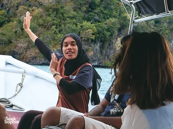 Travellers on a cruise boat at Tanjung Rhu UNESCO Geopark, Langkawi, as a naturalist guides wildlife sightseeing