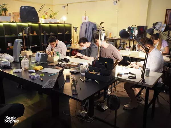 Singapore silversmithing studio with several learners working at benches and casting tools under task lamps for workshops in Singapore