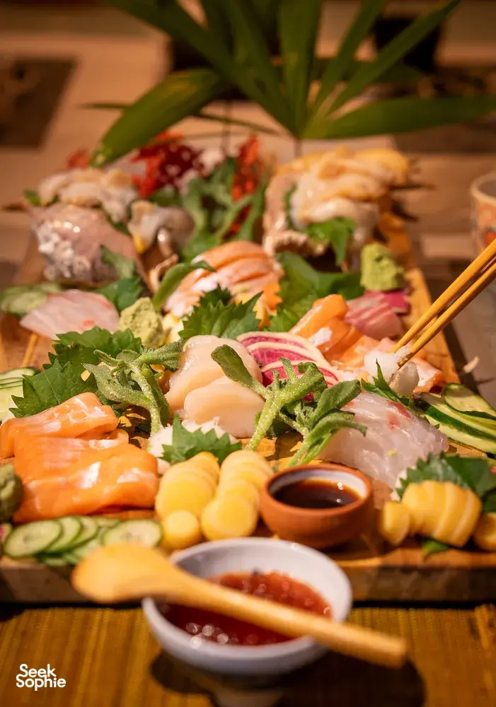 Primateve grazing platter spread of sashimi, vegetables and dipping sauces with chopsticks at a private dining Singapore experience