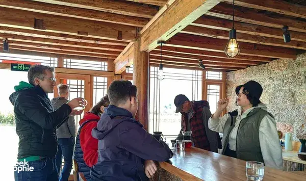 Guests cupping Yunnan specialty coffee at a family-run workshop in Lijiang, tasting from small cups and discussing flavours