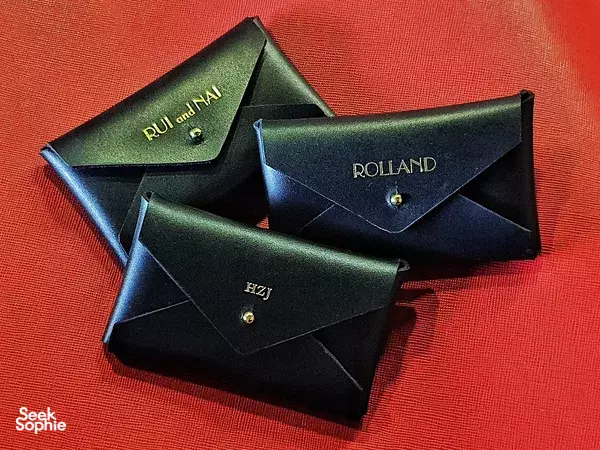 Handcrafted leather cardholders for a mailer set shown on red fabric at Kult Bespoke in Singapore, ideal for workshops in Singapore