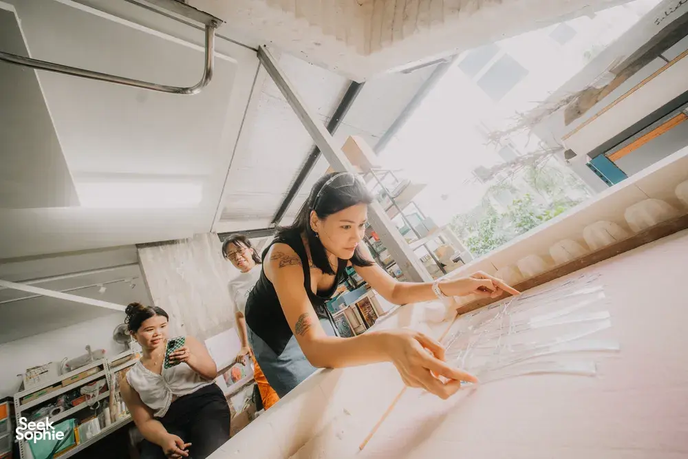 Guests arranging glass pieces at Art Glass Centre in Singapore during a centrepiece-making workshop — workshops in Singapore