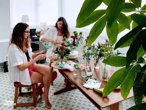 Guests sit at a table arranging small bouquets as part of a mindful flower workshop in a Tiong Bahru heritage home for workshops in Singapore