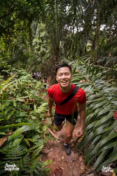 Hiker trekking along a muddy jungle path in Mount Faber, guided through wartime ruins in Singapore — Singapore hidden gems