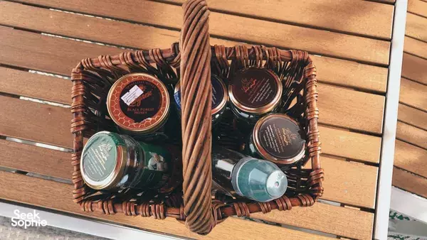 Wicker tray of labelled honey jars on a wooden bench during a Private Urban Farm Experience in Singapore