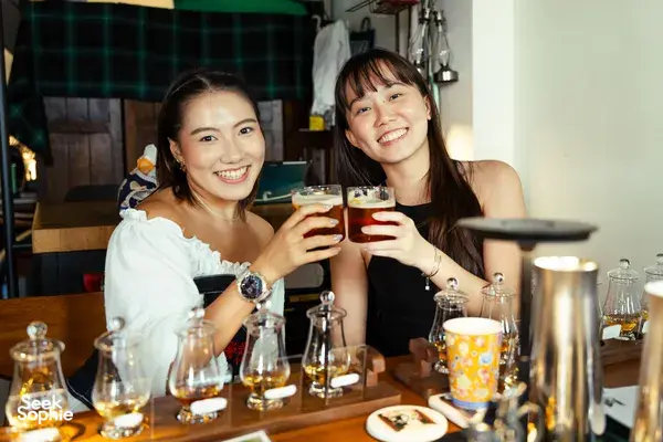 Guests clink small-batch whisky glasses at Scotch & Sambal’s hidden home bar in Singapore for private dining Singapore