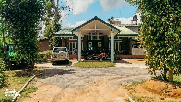 Old Frankland Tea Estate lodge entrance and driveway in Kandy tea country, with parking spaces and surrounded greenery