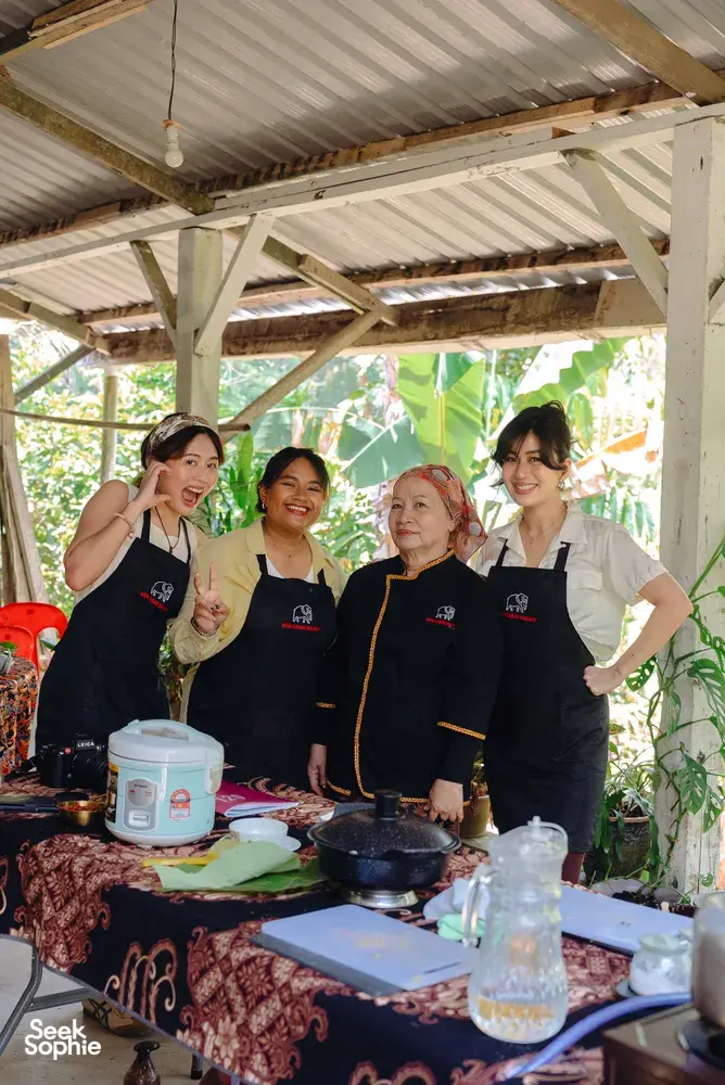 Indigenous Sabahan cooking with a local family in Kota Kinabalu, Borneo—four hosts posing at a covered food station