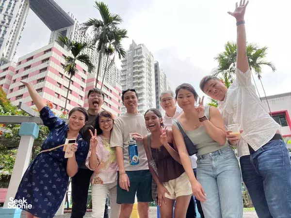 Team members cheer with drinks outside in Singapore’s Kampong Gelam during an immersive heritage adventure, uncovering Singapore hidden gems