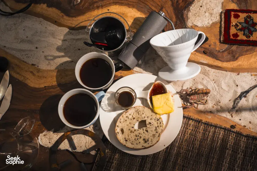 Brunch plate with a buttered bagel, jam, and two cups of coffee, plus pour-over equipment laid out in Singapore — workshops in Singapore