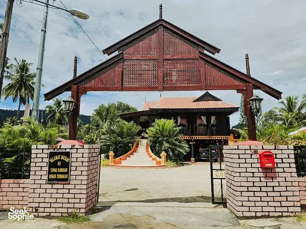 Red-roofed building entrance and gate in Langkawi, a landmark start along the villages, markets and jetty cycling route