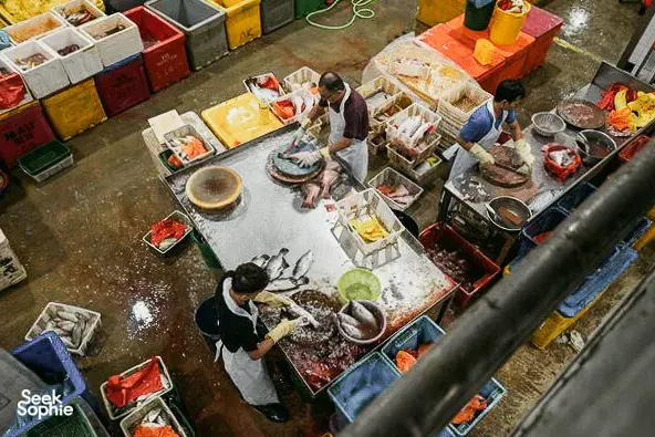 Orang-orang menangani lapak ikan dan makanan laut di pasar ikan pelabuhan Jurong yang ramai di Singapura selama tur berpemandu