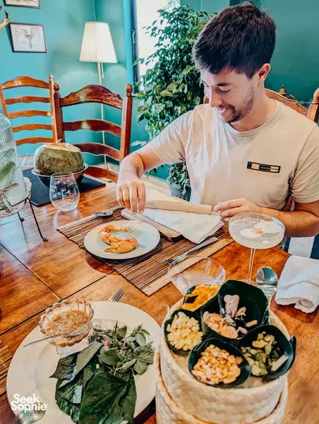 Farm-to-table dinner spread with plates of vegetables on a wooden table inside a seaside farm in Singapore, Singapore hidden gems