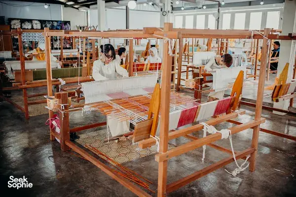 Handweaving on traditional wooden looms at Tanoti Crafts’ Kuching atelier, practising indigenous textile craft