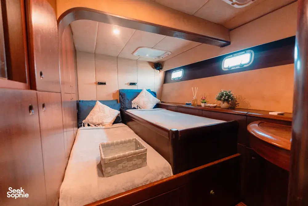 Mawali catamaran cabin in Kota Kinabalu, Sabah, with two bunks, pillows and a reading light for a restful overnight sail