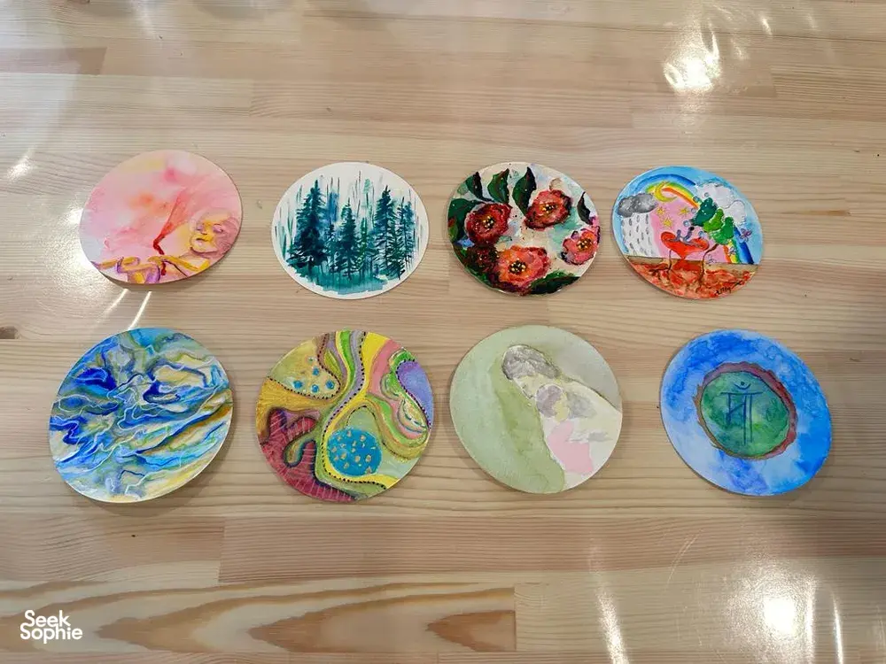 Art For Good art therapy in Singapore: circular painted artworks arranged on the studio floor during workshops in Singapore