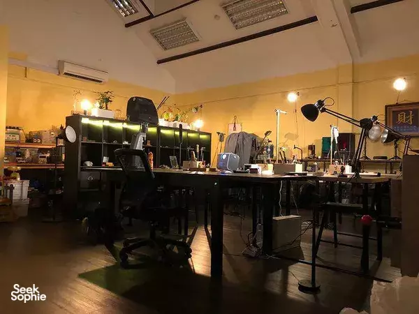 Wide view of a Singapore jewellery-making workshop with benches, shelves and metalworking lamps for workshops in Singapore