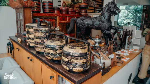 Antique kueh moulds, tins and serving tools arranged on a wooden sideboard in a Singapore home — workshops in Singapore