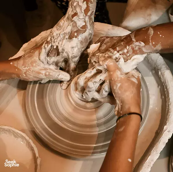 Hands shaping clay on a pottery wheel during a Dirty Hands Only making session in Singapore, workshops in Singapore