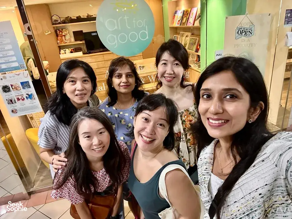 Art For Good art therapy in Singapore: group of participants posing at the studio entrance during workshops in Singapore
