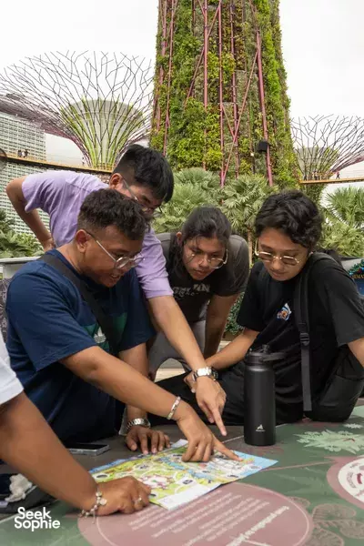 Sustainability puzzle hunt: team members solve the clue sheet at Marina Bay, Singapore with Monster Day Tours, team bonding activities Singapore