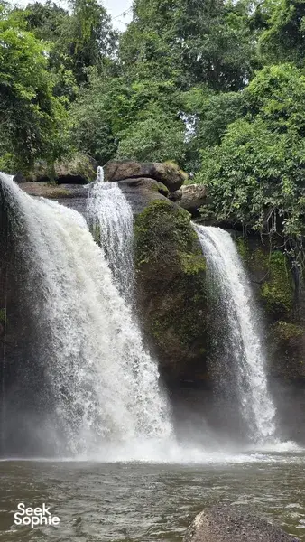Waterfalls cascading into a misty pool through lush forest in Khao Yai National Park, Wildlife Safari Thailand