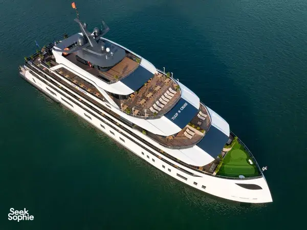 Doris Cruise 2D1N cruise ship gliding across Lan Ha Bay, aerial view over calm Vietnamese waters aboard the luxury vessel